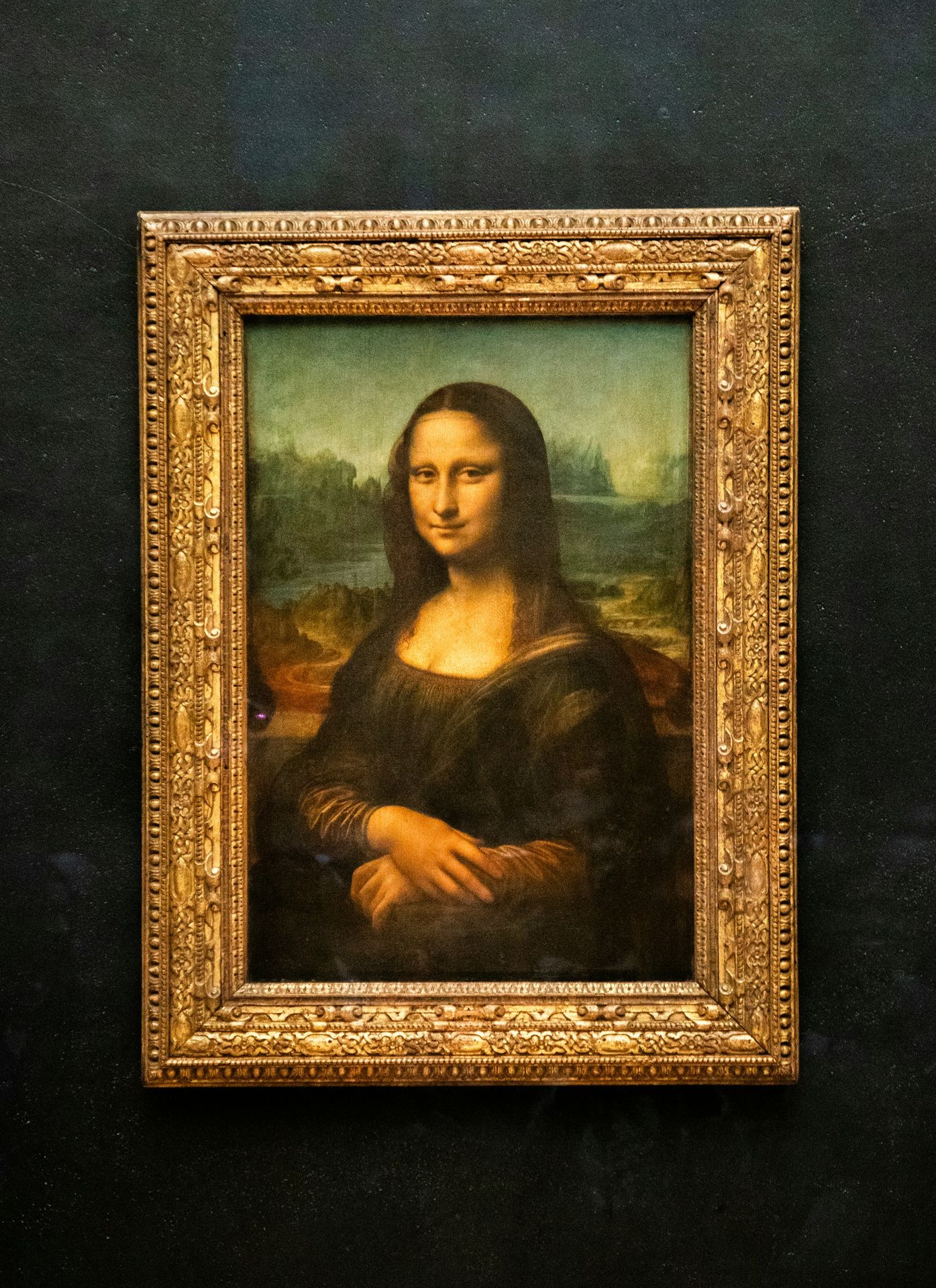 A painting of a woman in a gold frame